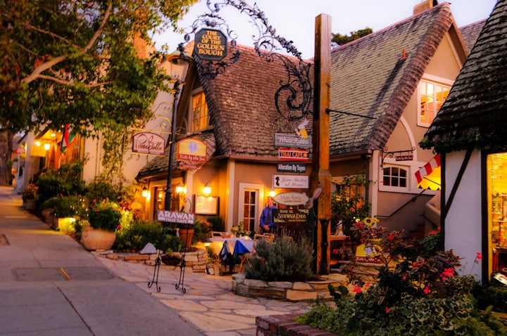 Cottage style shops lining Ocean Avenue in Carmel-by-the-Sea at dusk