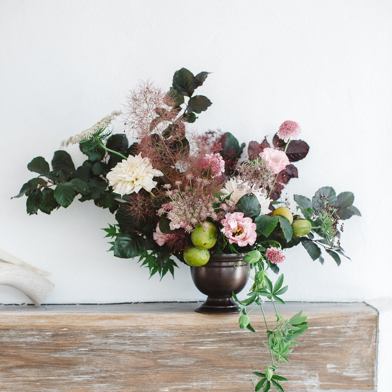Statement floral arrangement with dahlias, smoke bush and pears designed for a Carmel resort