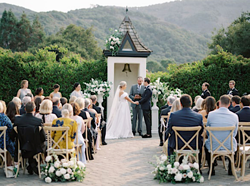 Outdoor wedding at Folktale Winery in front of tiny chapel structure and views of the Santa Lucia Mountains
