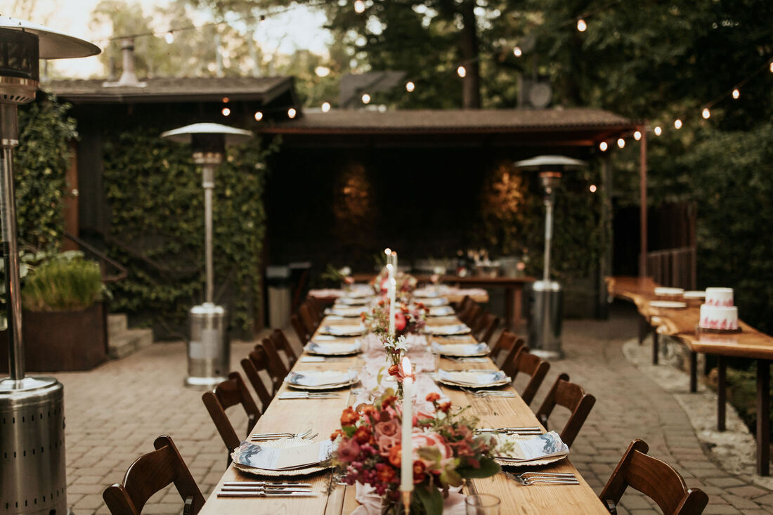 Lush flower centerpieces in soft autumn colors created by Big Sur florist on dining tables at Glen Oaks